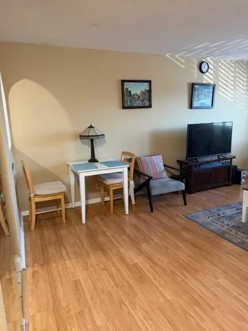a living room with furniture a piano and a flat screen tv