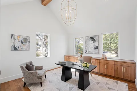 a room with a table chairs and a window