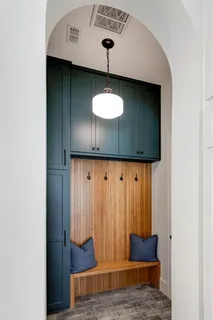 a living room with furniture a ceiling fan and a large window