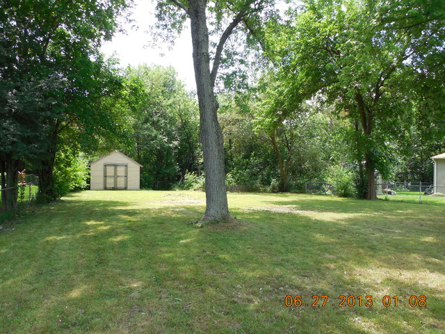 123 East Oltendorf Road Streamwood, IL 60107 - Photo 3 of 15 a house with a big yard and large trees
