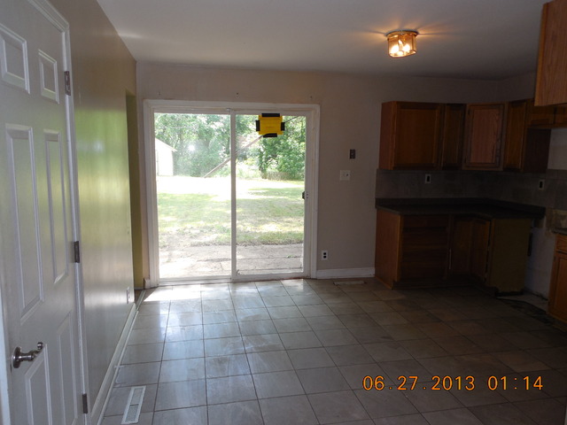 123 East Oltendorf Road Streamwood, IL 60107 - Photo 6 of 15 a view of an empty room with a fireplace and a window