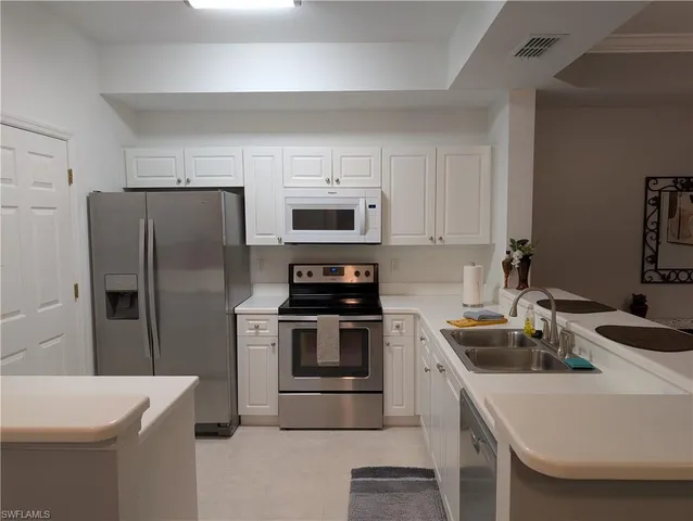 a kitchen with a sink a stove and refrigerator
