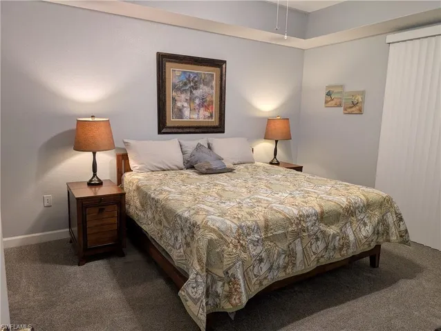 a bedroom with a bed and lamp