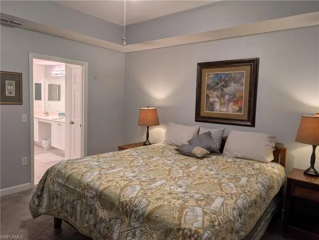 a bedroom with a bed and a painting on the wall