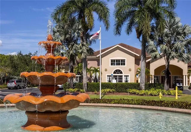 a front view of a house with a yard and potted plants