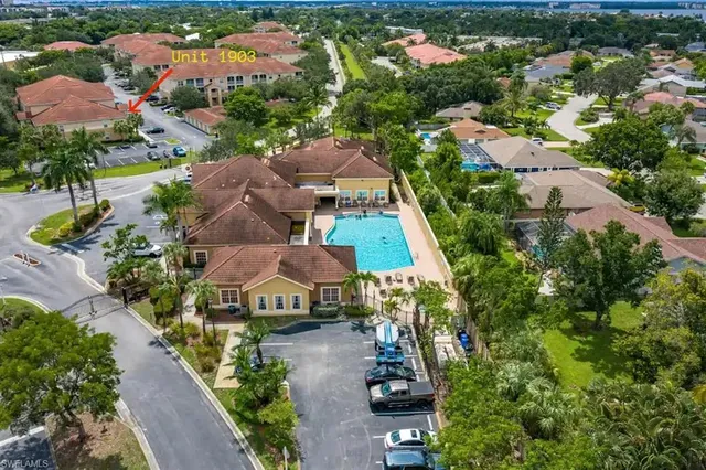 an aerial view of multiple houses with yard
