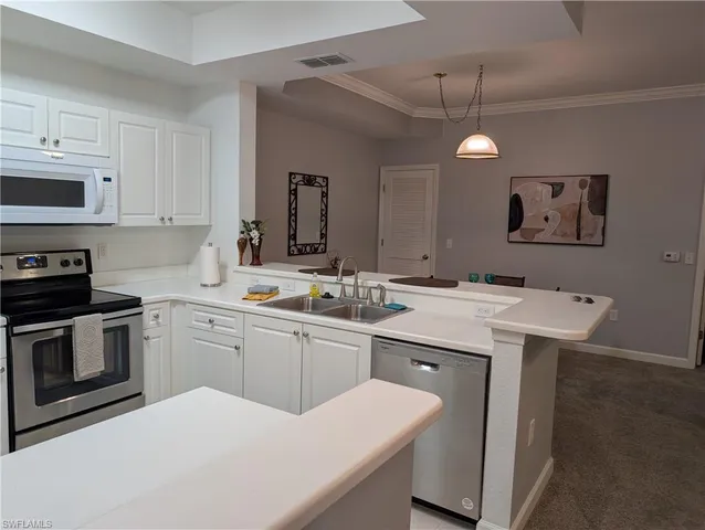 a kitchen with a sink stove and microwave