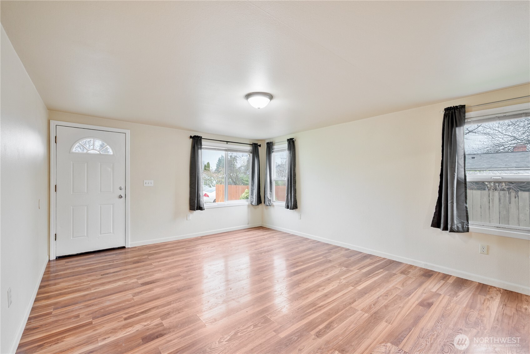 96 Dirk Lane Kelso, WA 98626 - Photo 2 of 13 a view of an empty room with wooden floor and a window
