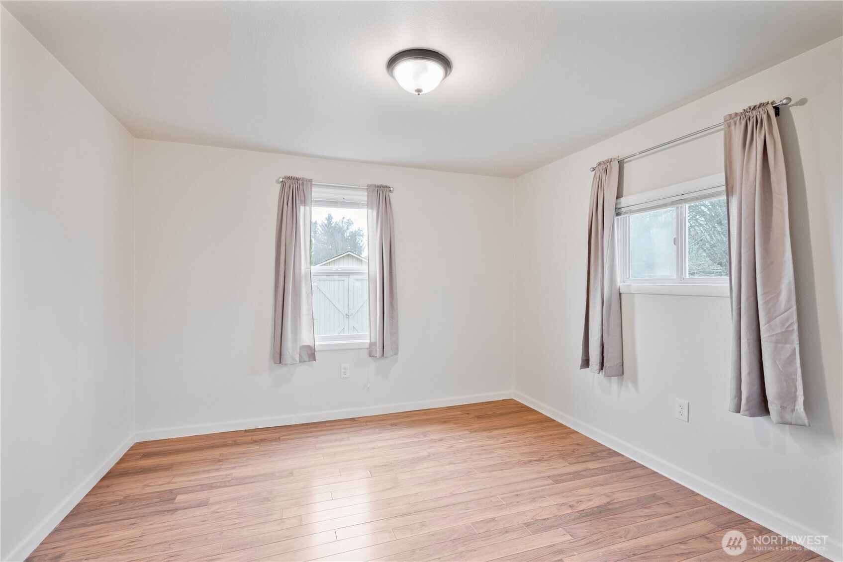 96 Dirk Lane Kelso, WA 98626 - Photo 7 of 13 an empty room with wooden floor and windows