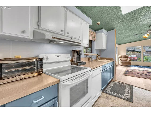 a kitchen with a sink cabinets and window