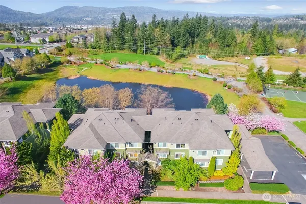 an aerial view of residential houses with outdoor space and swimming pool