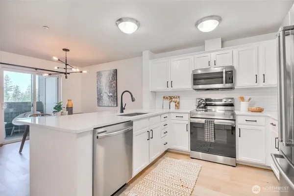 a kitchen with white cabinets and white appliances
