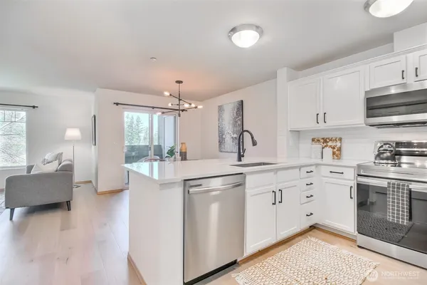 a kitchen with stainless steel appliances a refrigerator stove microwave and cabinets