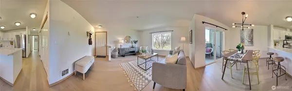 a living room with furniture wooden floor and a large window