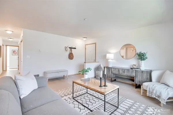 a living room with furniture and a potted plant