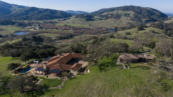 an aerial view of a house with mountain view