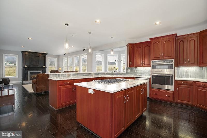 4320 Valley View Road Middletown, MD 21769 - Photo 7 of 30 a kitchen with stainless steel appliances granite countertop a stove a sink dishwasher a refrigerator and a oven with wooden floor