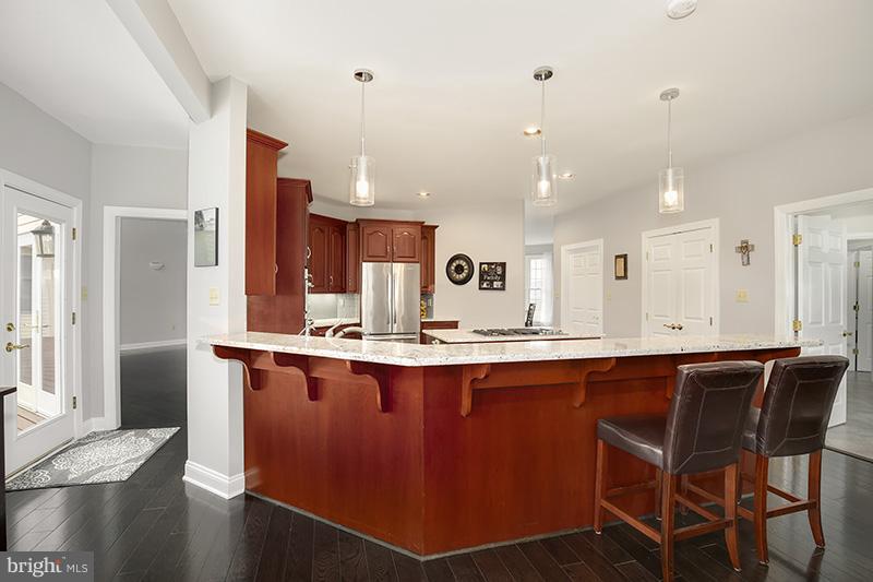 4320 Valley View Road Middletown, MD 21769 - Photo 9 of 30 a kitchen with stainless steel appliances granite countertop a sink a stove a refrigerator and island with wooden floor