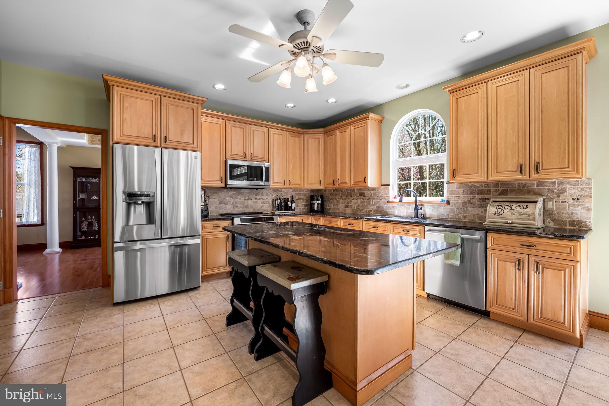 6815 Cherry Tree Court New Market, MD 21774 - Photo 15 of 86 a kitchen with stainless steel appliances granite countertop a stove refrigerator sink and dishwasher