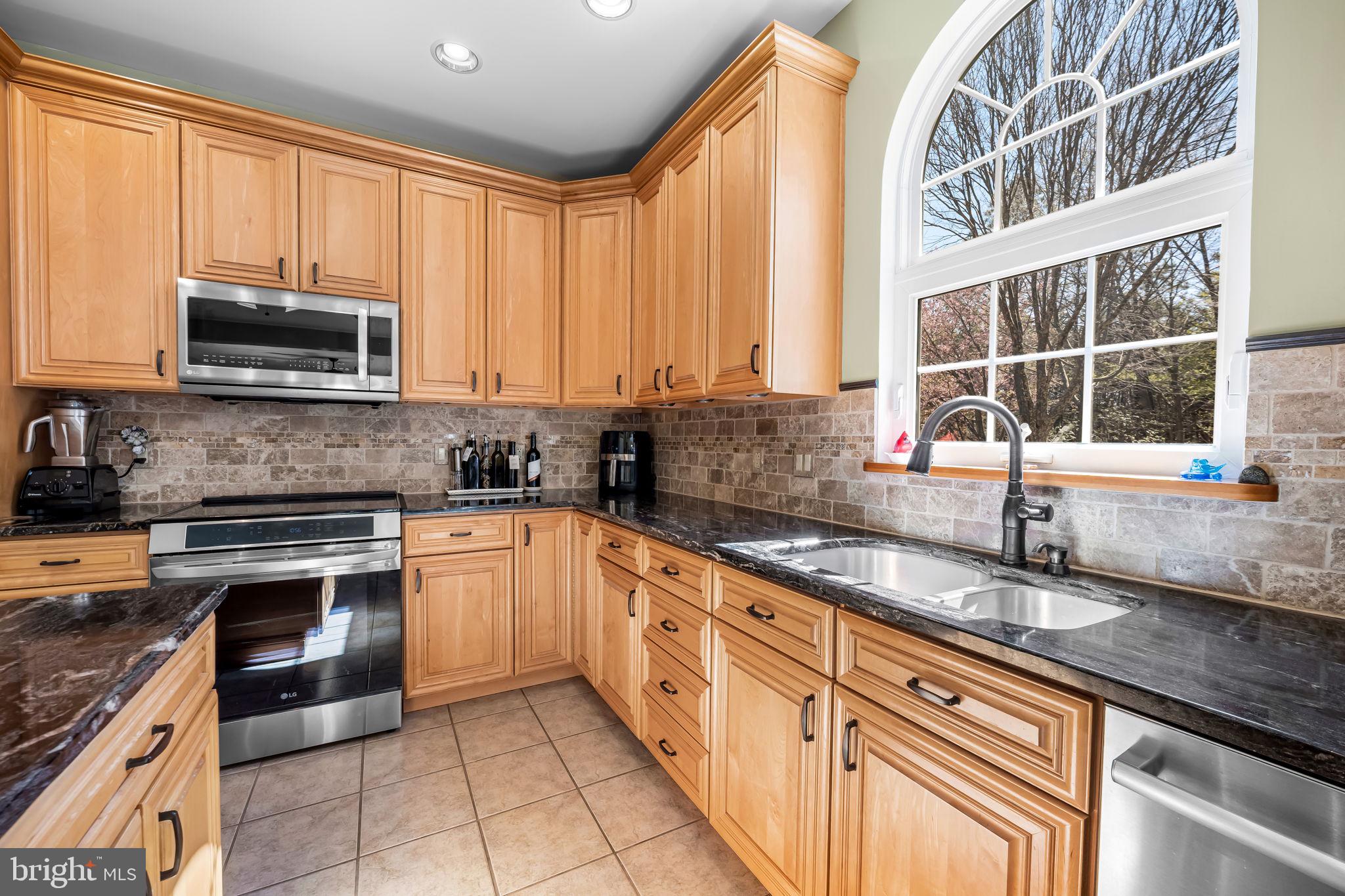 6815 Cherry Tree Court New Market, MD 21774 - Photo 18 of 86 a kitchen with stainless steel appliances granite countertop a sink and a stove