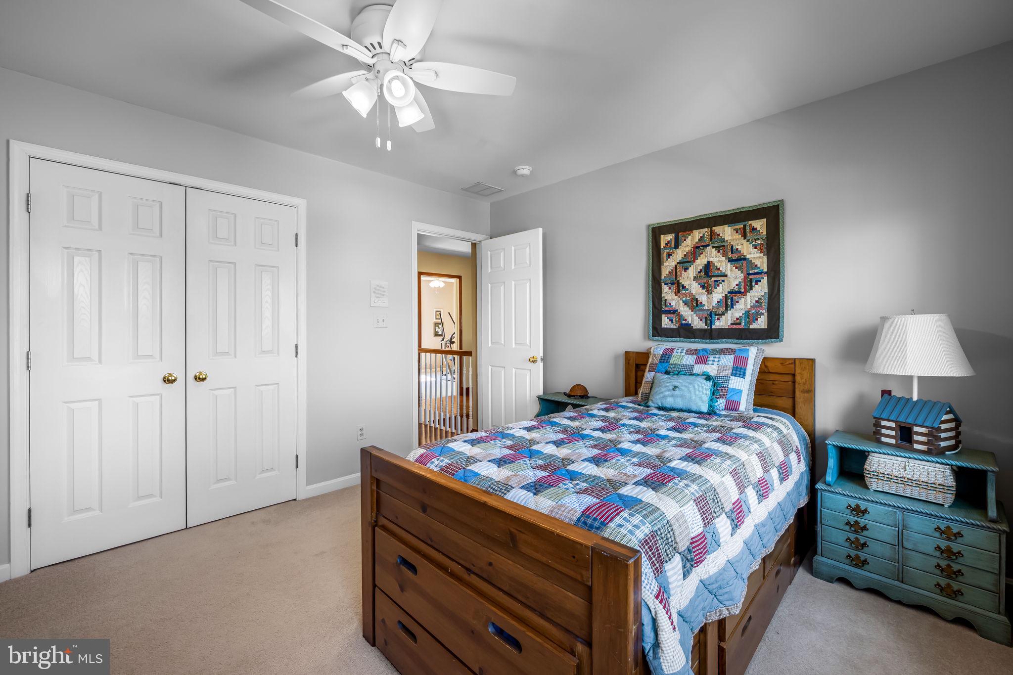 6815 Cherry Tree Court New Market, MD 21774 - Photo 30 of 86 a bedroom with a bed and a painting on the wall