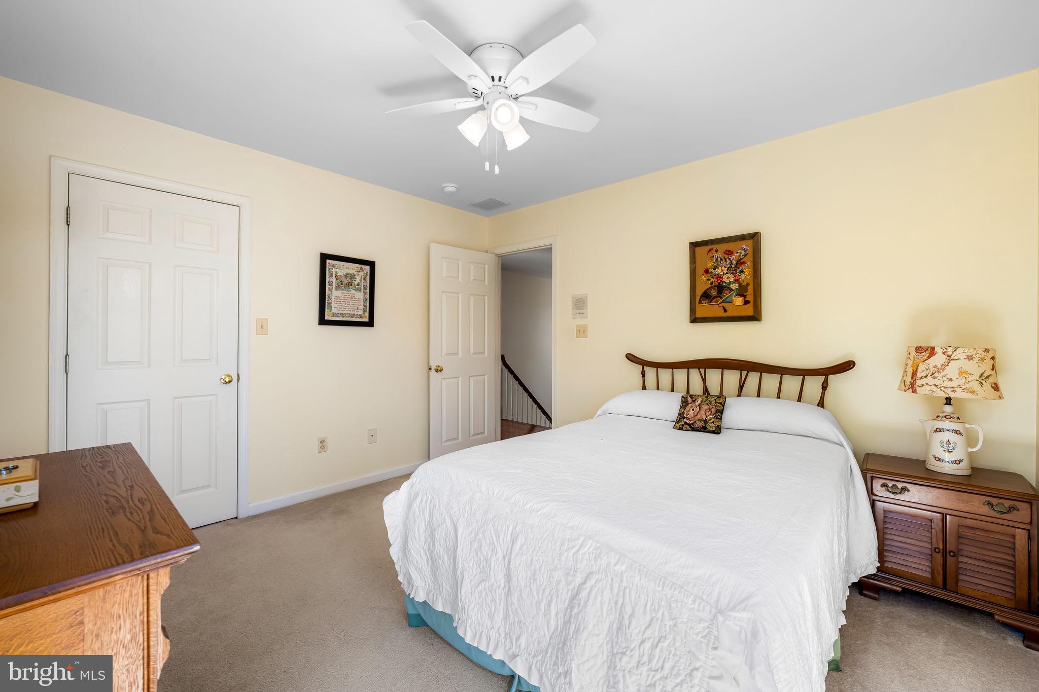 6815 Cherry Tree Court New Market, MD 21774 - Photo 33 of 86 a bedroom with a bed and a chandelier