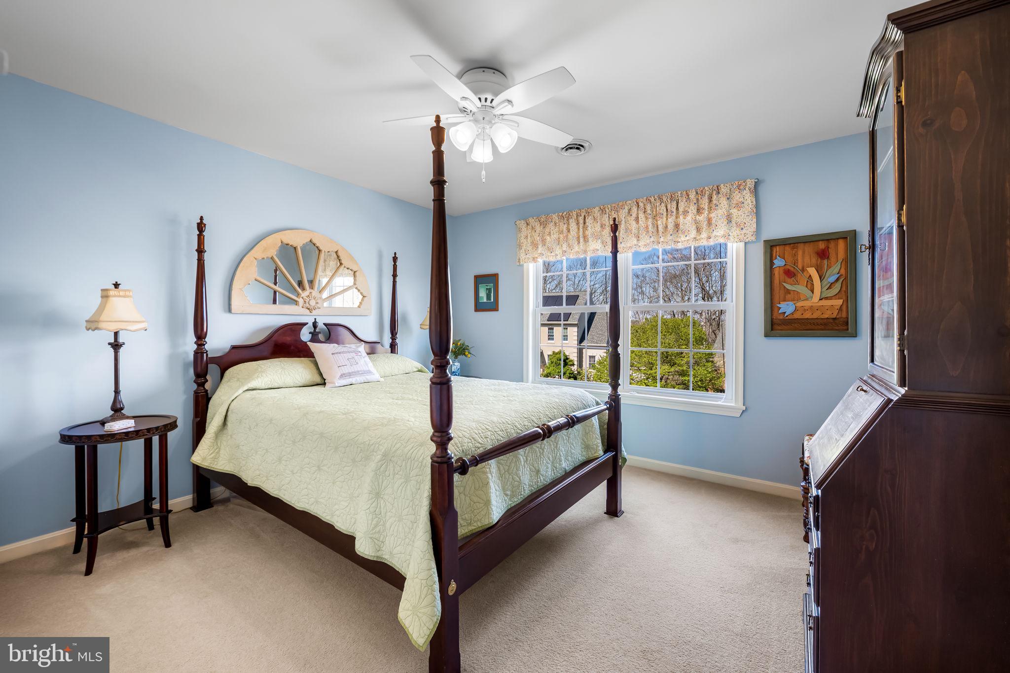 6815 Cherry Tree Court New Market, MD 21774 - Photo 37 of 86 a bedroom with a bed and a chandelier next to a window