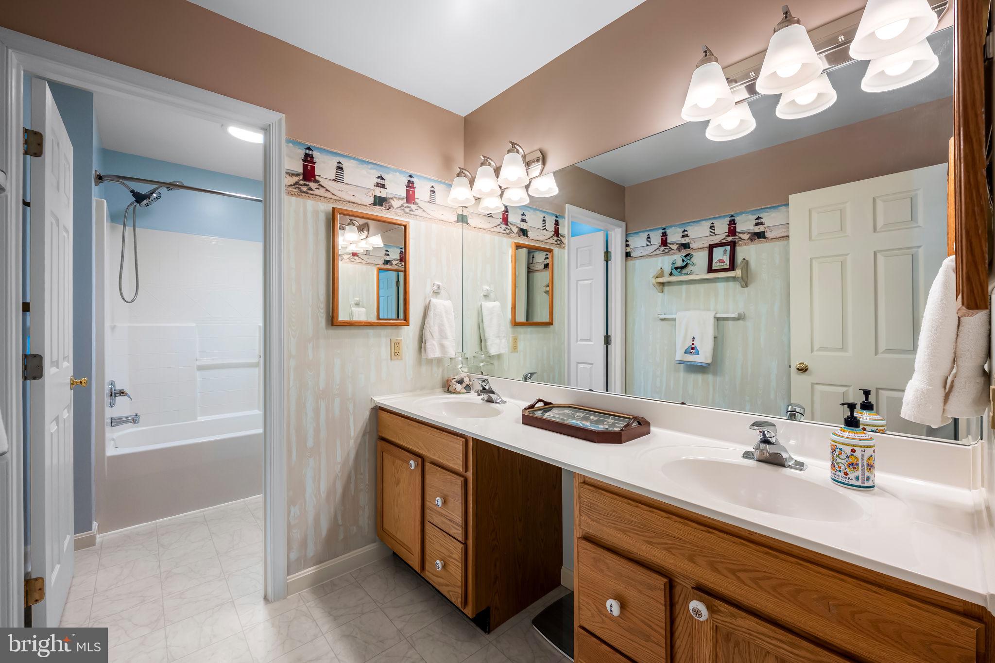 6815 Cherry Tree Court New Market, MD 21774 - Photo 39 of 86 a bathroom with a sink double vanity granite tub shower and a mirror