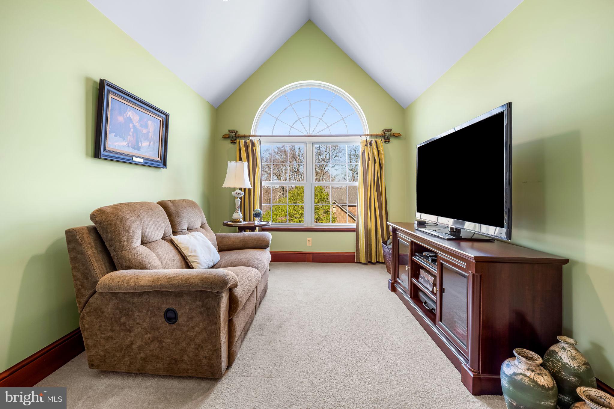 6815 Cherry Tree Court New Market, MD 21774 - Photo 45 of 86 a living room with furniture and a flat screen tv
