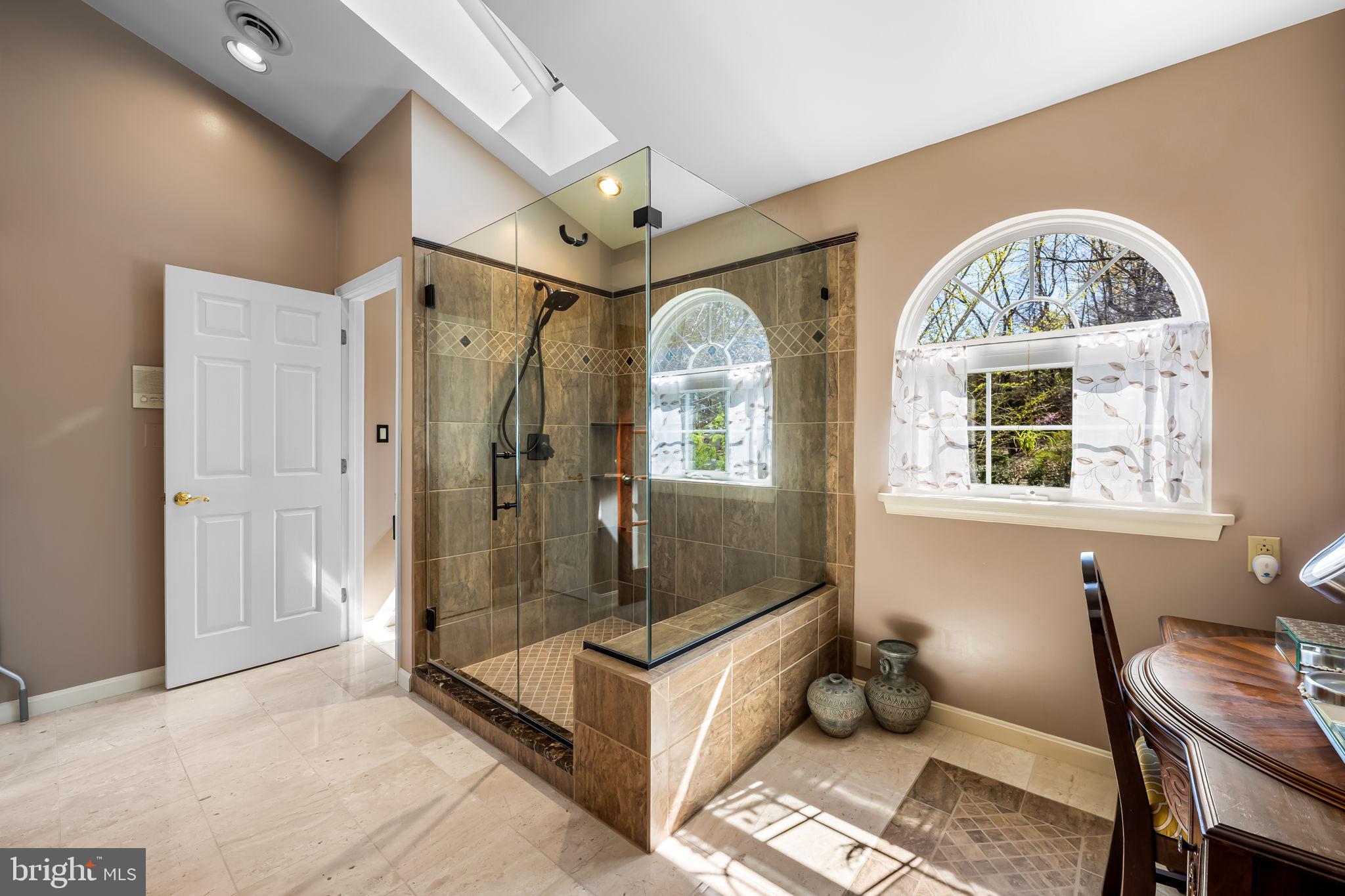 6815 Cherry Tree Court New Market, MD 21774 - Photo 48 of 86 a spacious bathroom with a granite countertop tub shower and mirror
