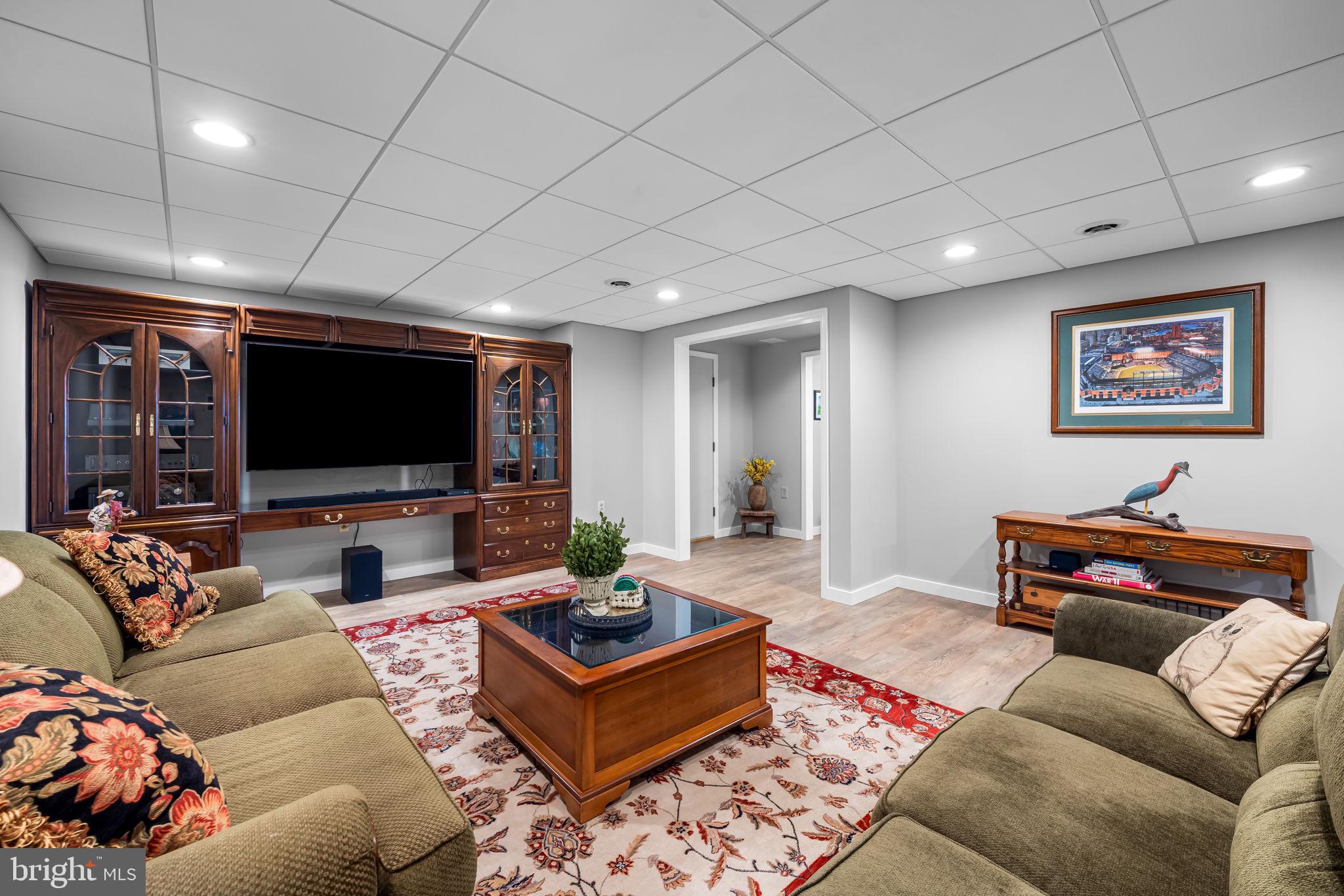 6815 Cherry Tree Court New Market, MD 21774 - Photo 51 of 86 a living room with furniture and a flat screen tv