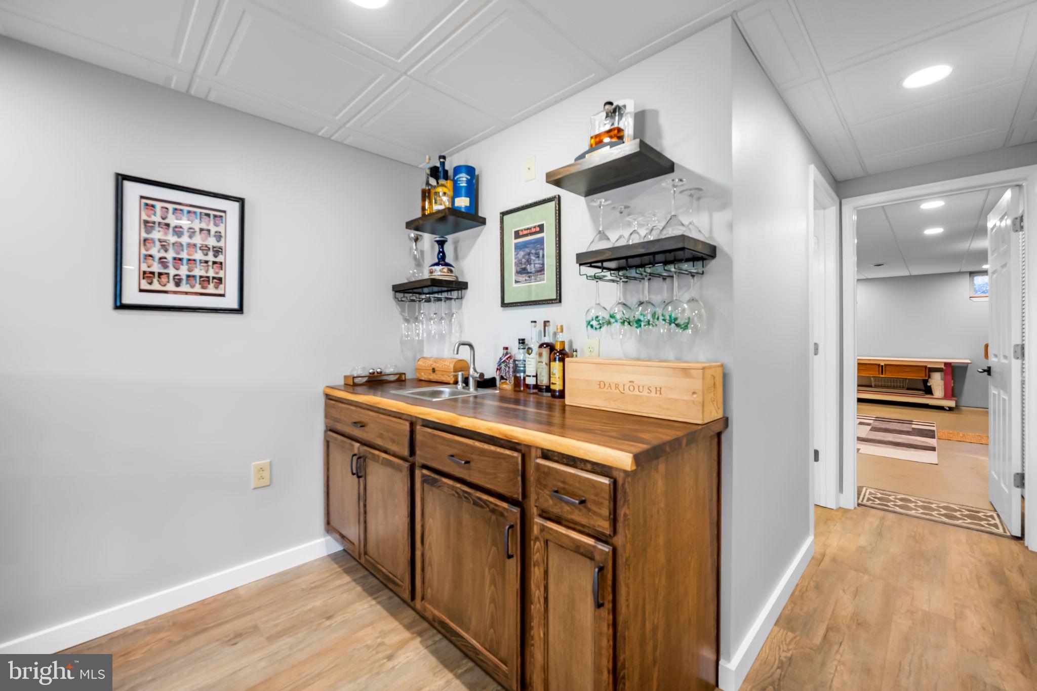 6815 Cherry Tree Court New Market, MD 21774 - Photo 56 of 86 a kitchen with cabinets and wooden floor