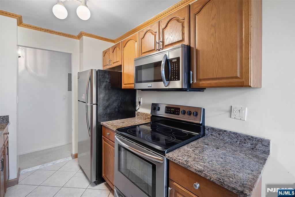 307 Prospect Avenue, Unit 14D Hackensack, NJ 07601 - Photo 11 of 18 a kitchen with stainless steel appliances granite countertop a refrigerator and a stove top oven