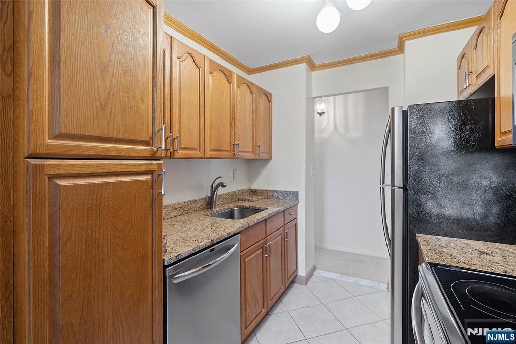 307 Prospect Avenue, Unit 14D Hackensack, NJ 07601 - Photo 12 of 18 a kitchen with stainless steel appliances granite countertop a refrigerator a stove and a sink