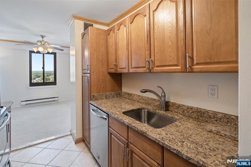 307 Prospect Avenue, Unit 14D Hackensack, NJ 07601 - Photo 13 of 18 a kitchen with stainless steel appliances granite countertop a sink and a white cabinets