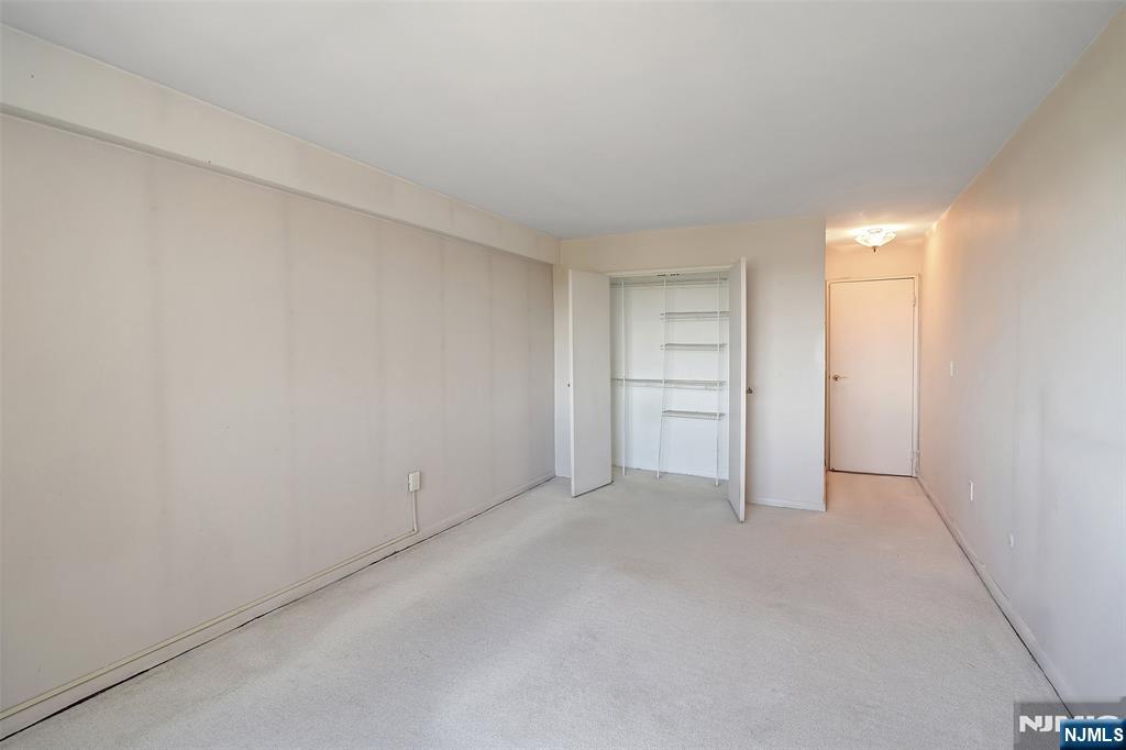 307 Prospect Avenue, Unit 14D Hackensack, NJ 07601 - Photo 16 of 18 a view of an empty room and a kitchen