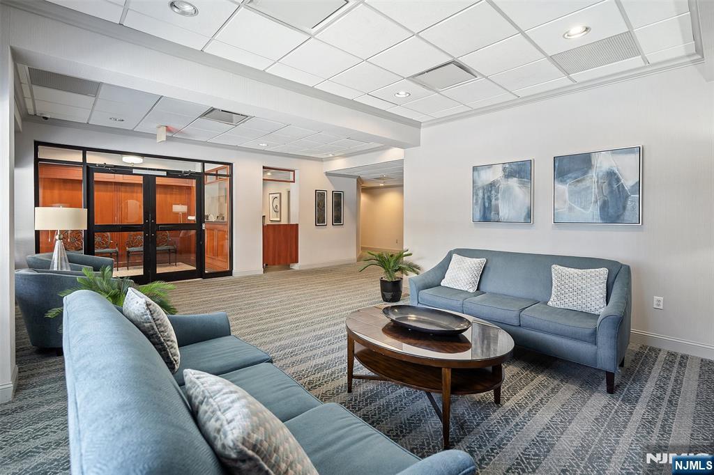 307 Prospect Avenue, Unit 14D Hackensack, NJ 07601 - Photo 2 of 18 a living room with furniture and a large window