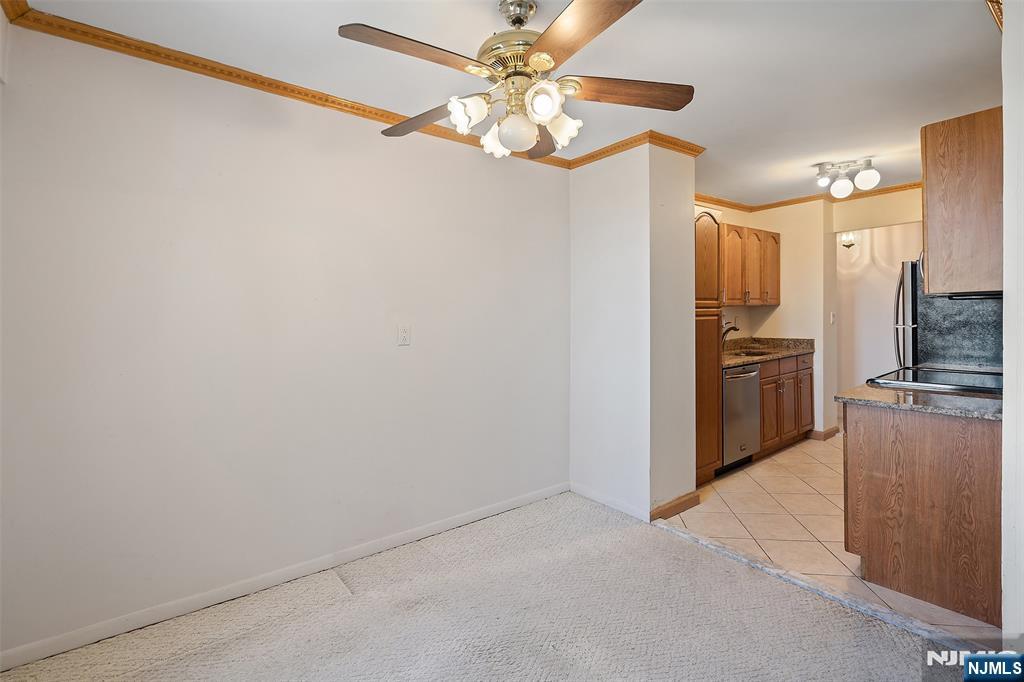 307 Prospect Avenue, Unit 14D Hackensack, NJ 07601 - Photo 10 of 18 a view of a kitchen with a sink and refrigerator