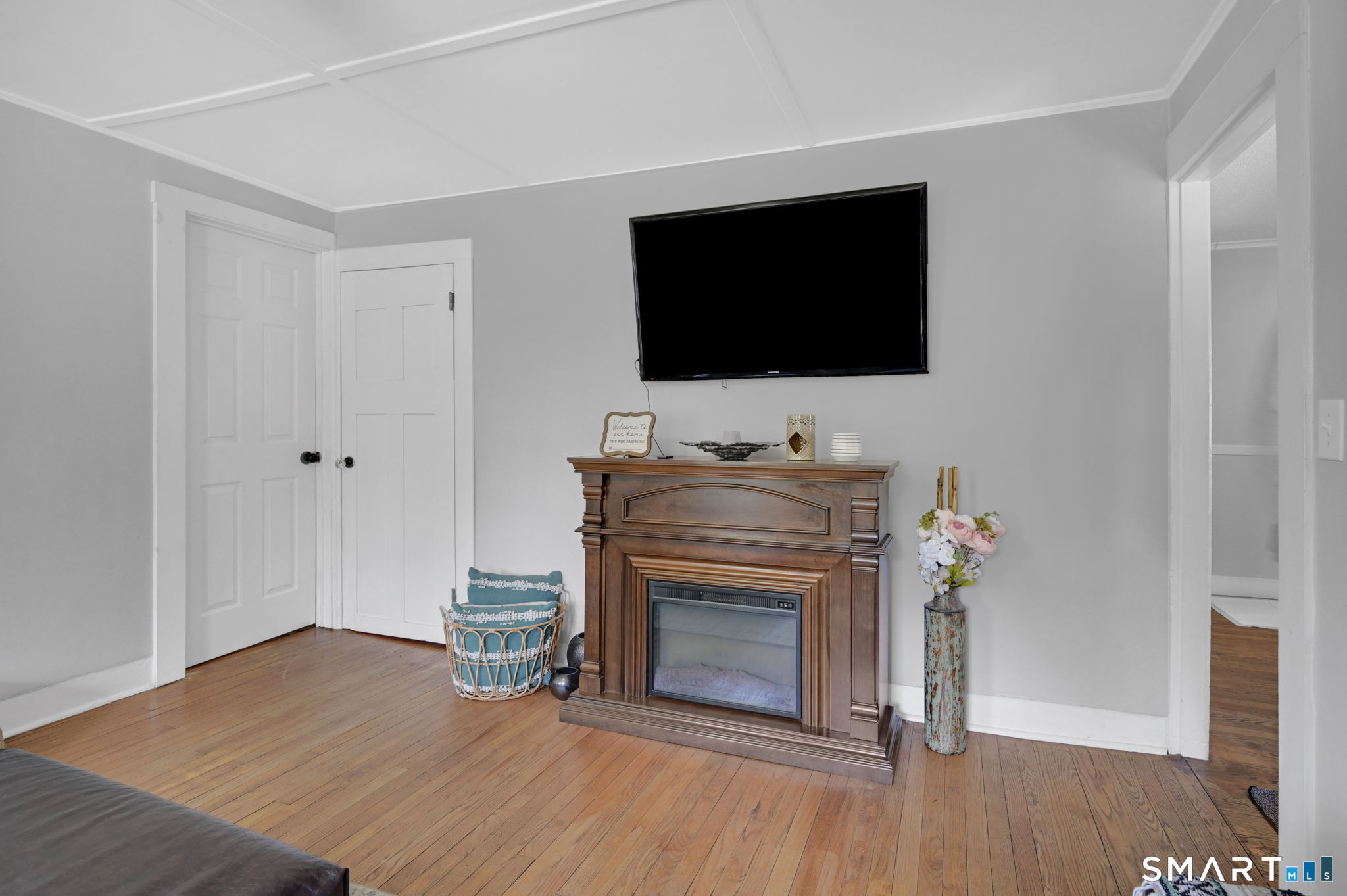 124 Prospect Street Vernon, CT 06066 - Photo 15 of 31 a living room with a fireplace and a flat screen tv