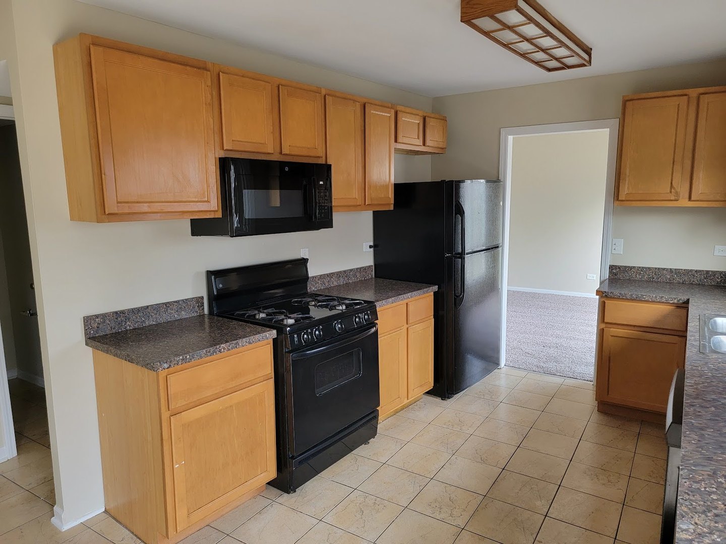 1935 Ashley Road Hoffman Estates, IL 60169 - Photo 12 of 28 a kitchen with granite countertop a refrigerator stove and microwave