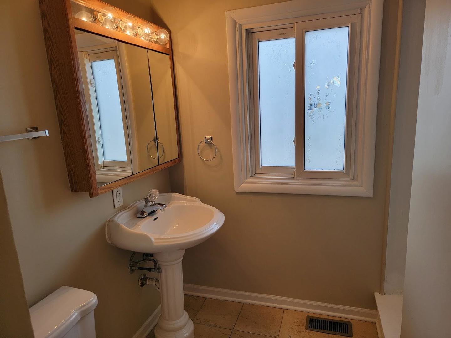 1935 Ashley Road Hoffman Estates, IL 60169 - Photo 18 of 28 a bathroom with a sink a mirror and a toilet
