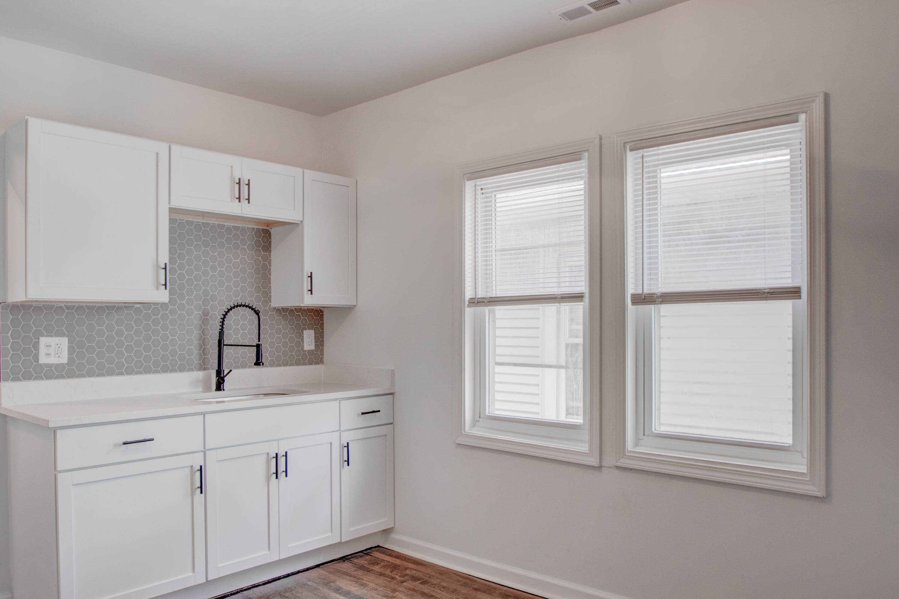613 Tennessee Street Gary, IN 46402 - Photo 16 of 39 a kitchen with white cabinets and sink