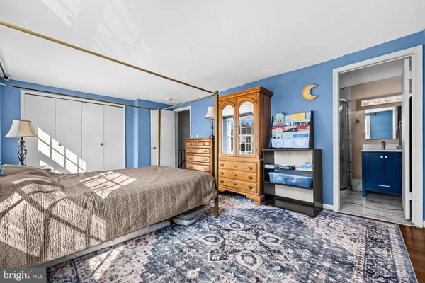a bedroom with a bed and a dresser