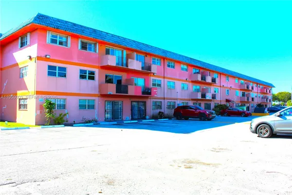 a view of building with parking area