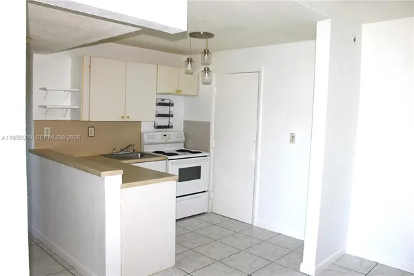 a kitchen with a stove cabinets and a refrigerator
