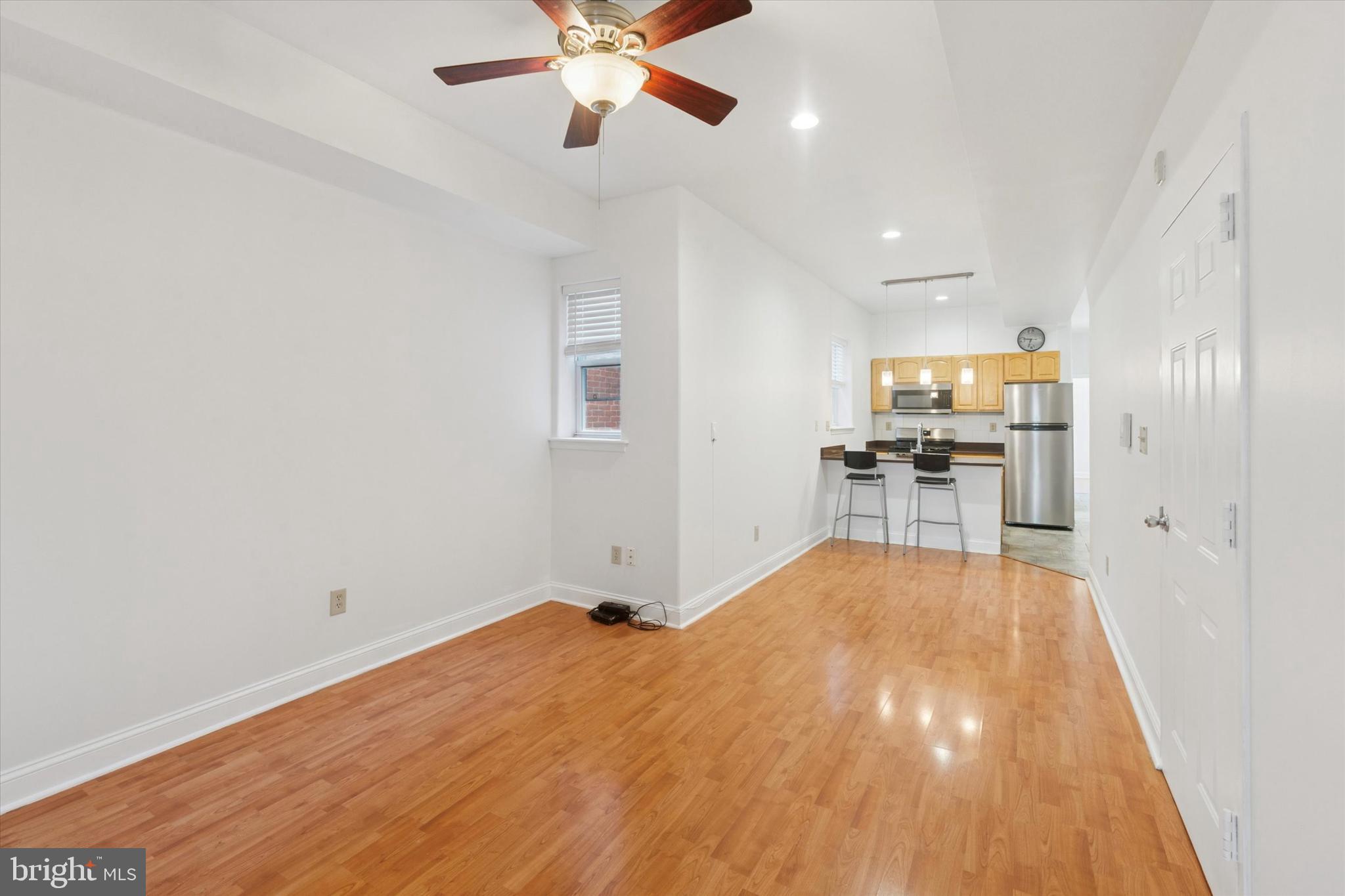 2522-24 South Broad Street, Unit 2F Philadelphia, PA 19145 - Photo 1 of 15 a view of a livingroom with a furniture wooden floor and a ceiling fan