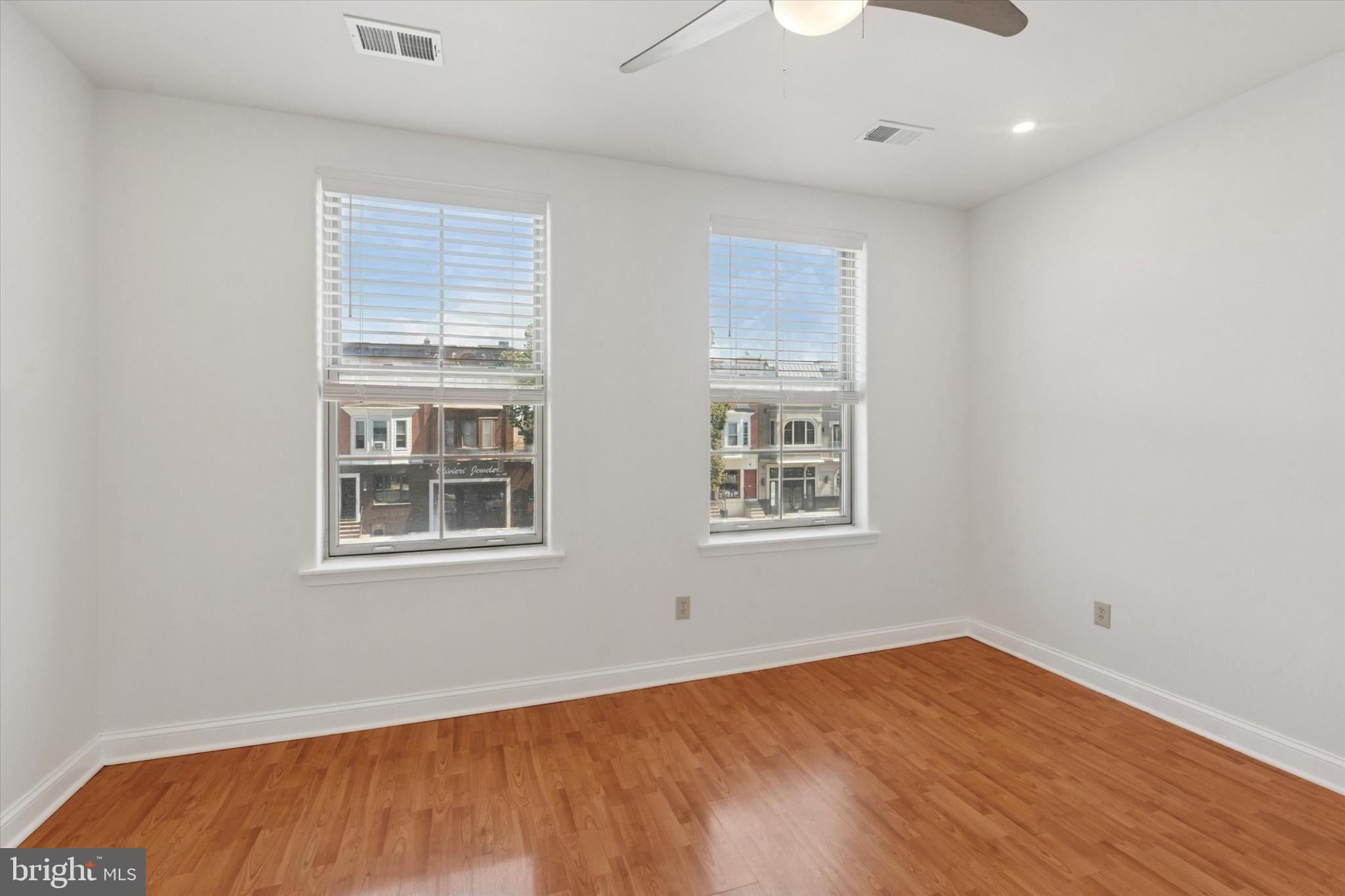 2522-24 South Broad Street, Unit 2F Philadelphia, PA 19145 - Photo 11 of 15 an empty room with wooden floor and windows