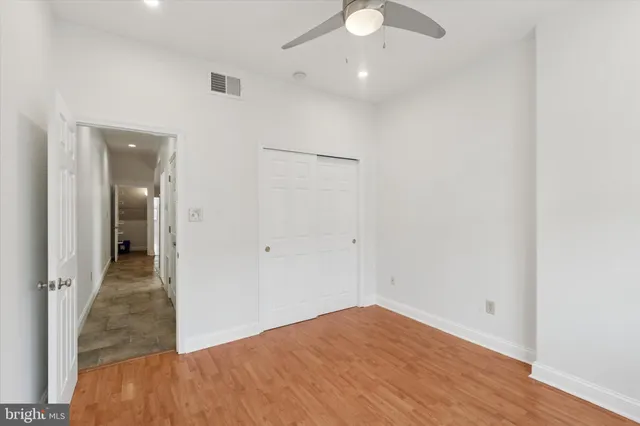 a view of hallway with wooden floor