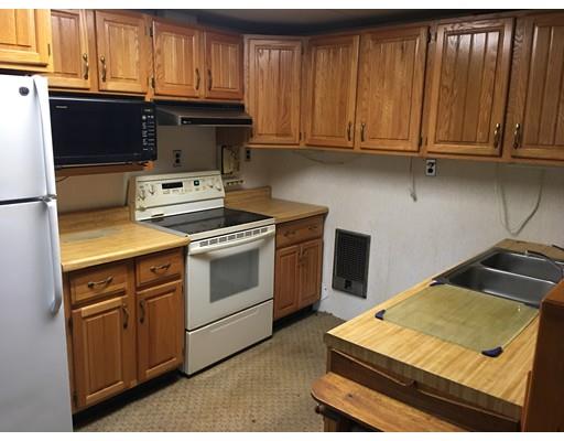 186 Flat Rock Road Athol, MA 01331 - Photo 8 of 13 a kitchen with wooden cabinets and a stove top oven