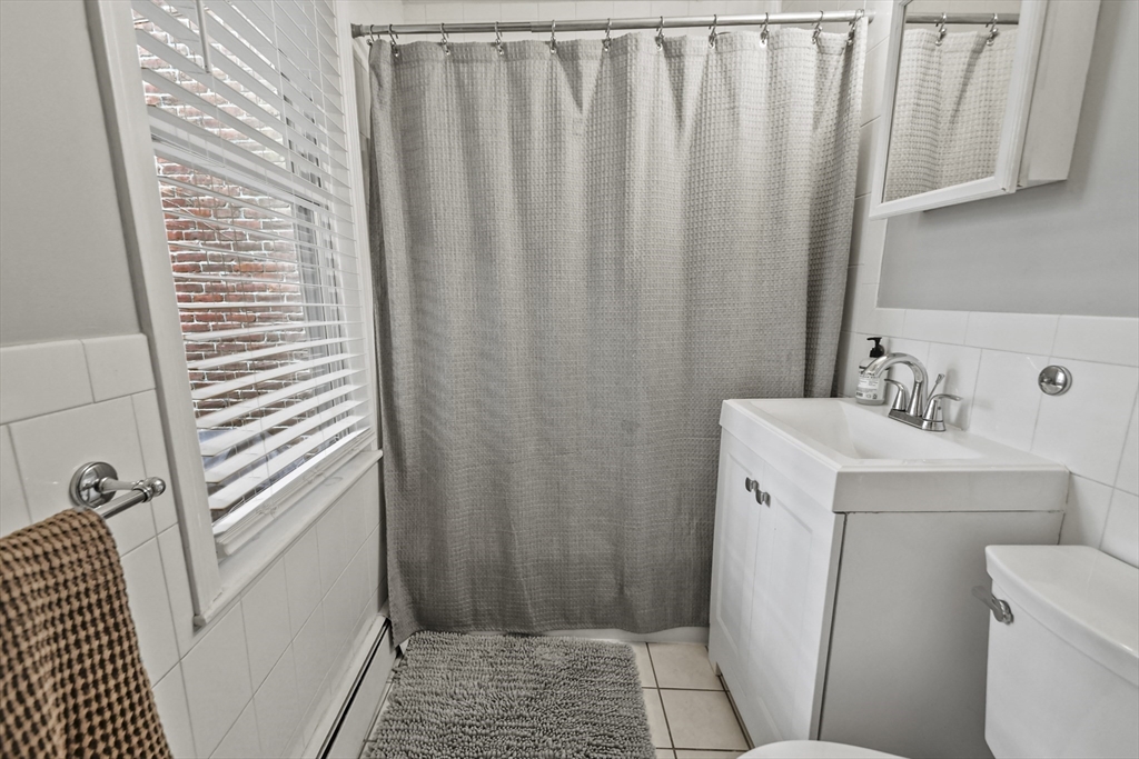 9 Allston Street, Unit 1 Boston, MA 02129 - Photo 16 of 19 a bathroom with a sink a toilet and shower